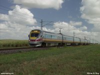 Brisbane bound electric Tilt Train approaching Route 3 level crossing.