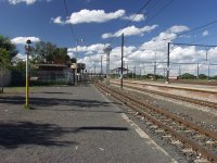 In the shadows, the signal cabin located on the north end of the station platform.